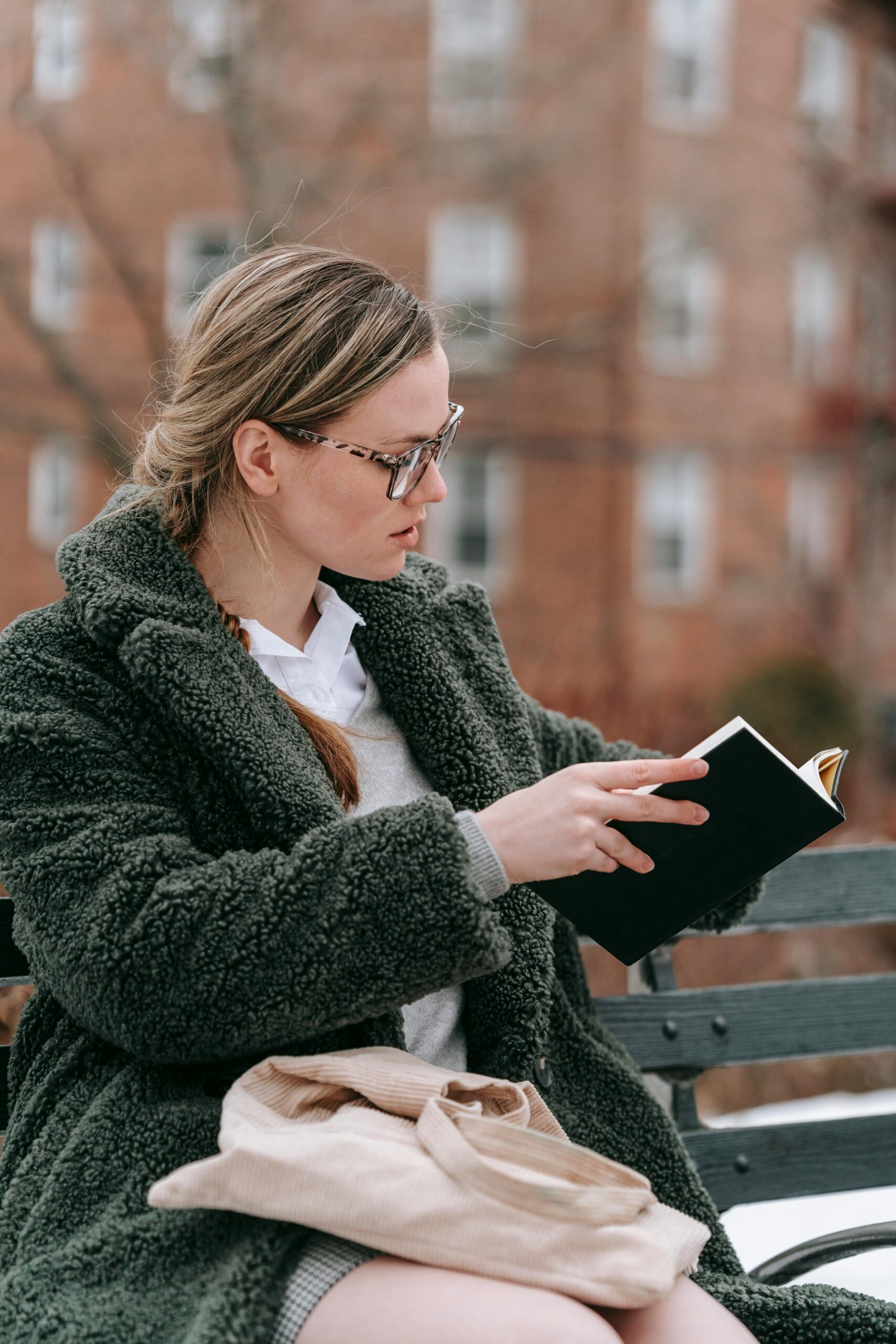 Hooggevoelige vrouw die in alle rust een boek leest op een bank om prikkels te verwerken.